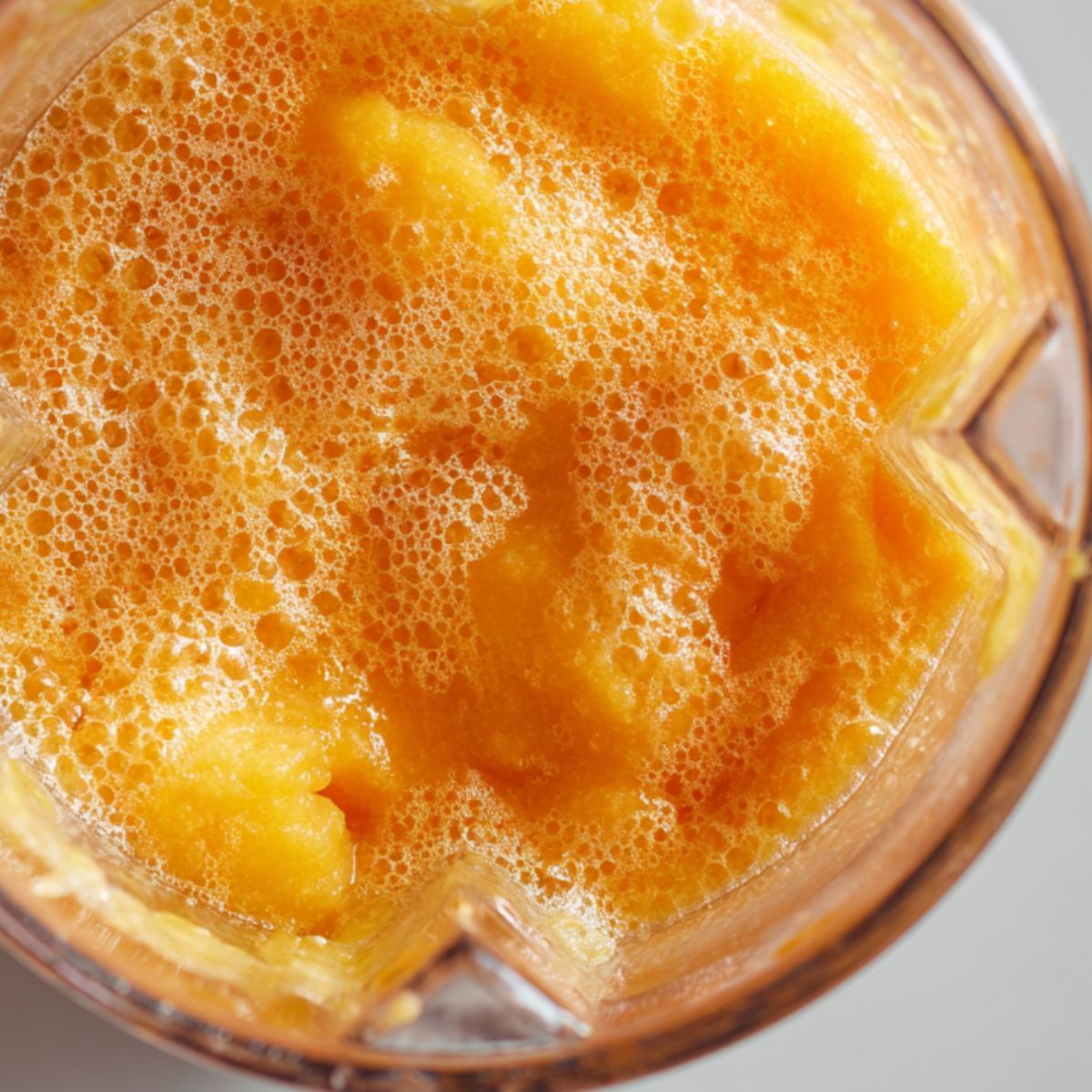 Blending the lemonade mixture with ice into a slushy texture