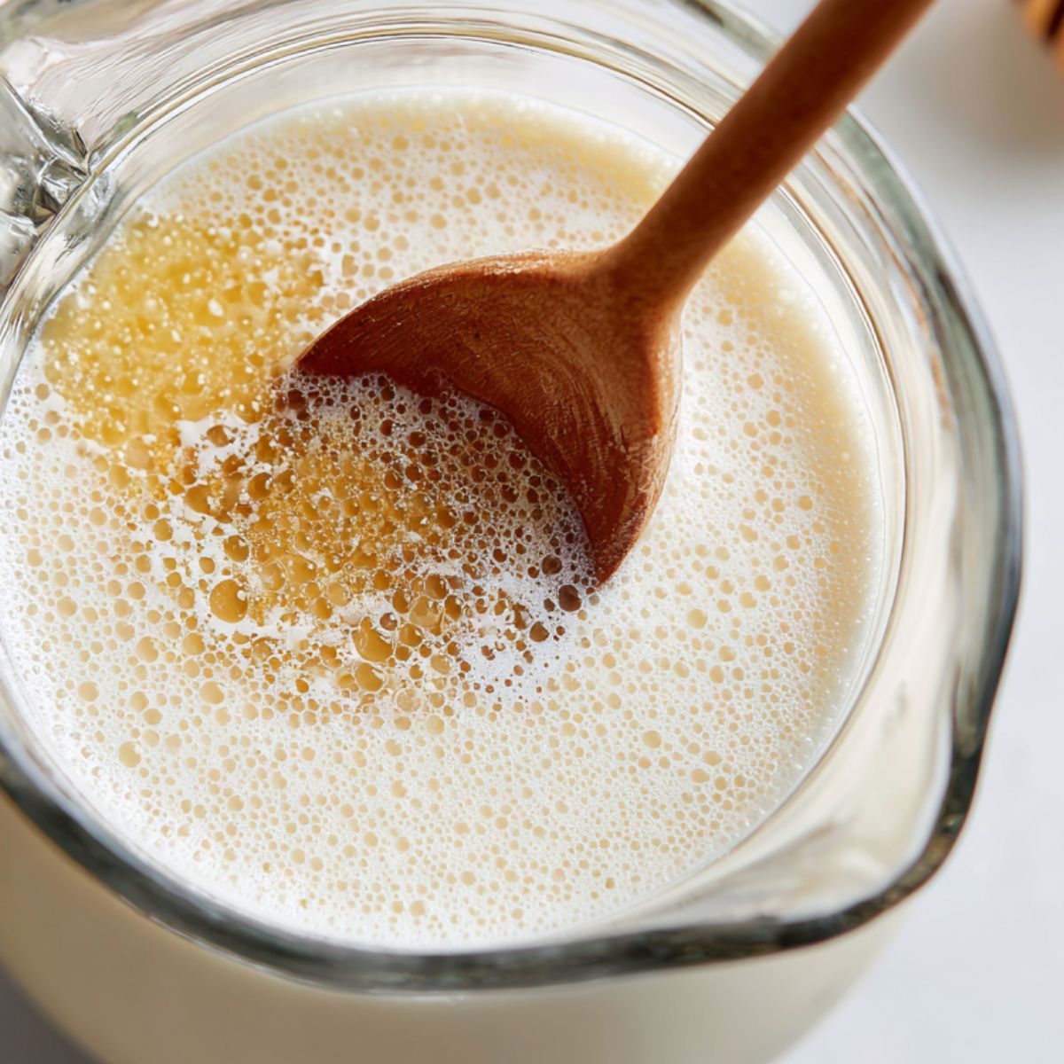 Stirring honey and lime juice into coconut mixture for limeade
