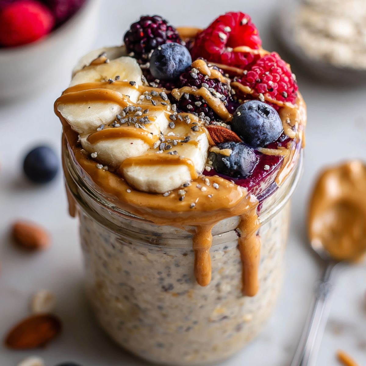 Finished oats topped with fresh fruit and nuts, ready to eat.
