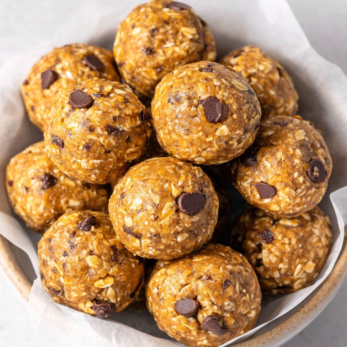 Homemade oatmeal peanut butter protein balls on a plate, top-down view.