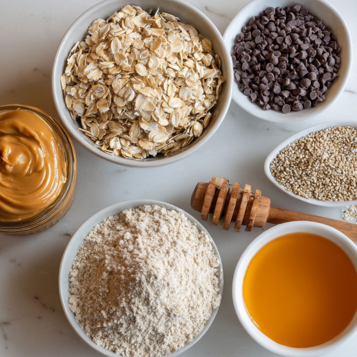 Ingredients for oatmeal peanut butter protein balls on a white kitchen counter.