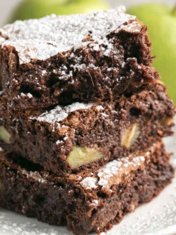 homemade apple brownies cut into rustic squares on a white kitchen counter.