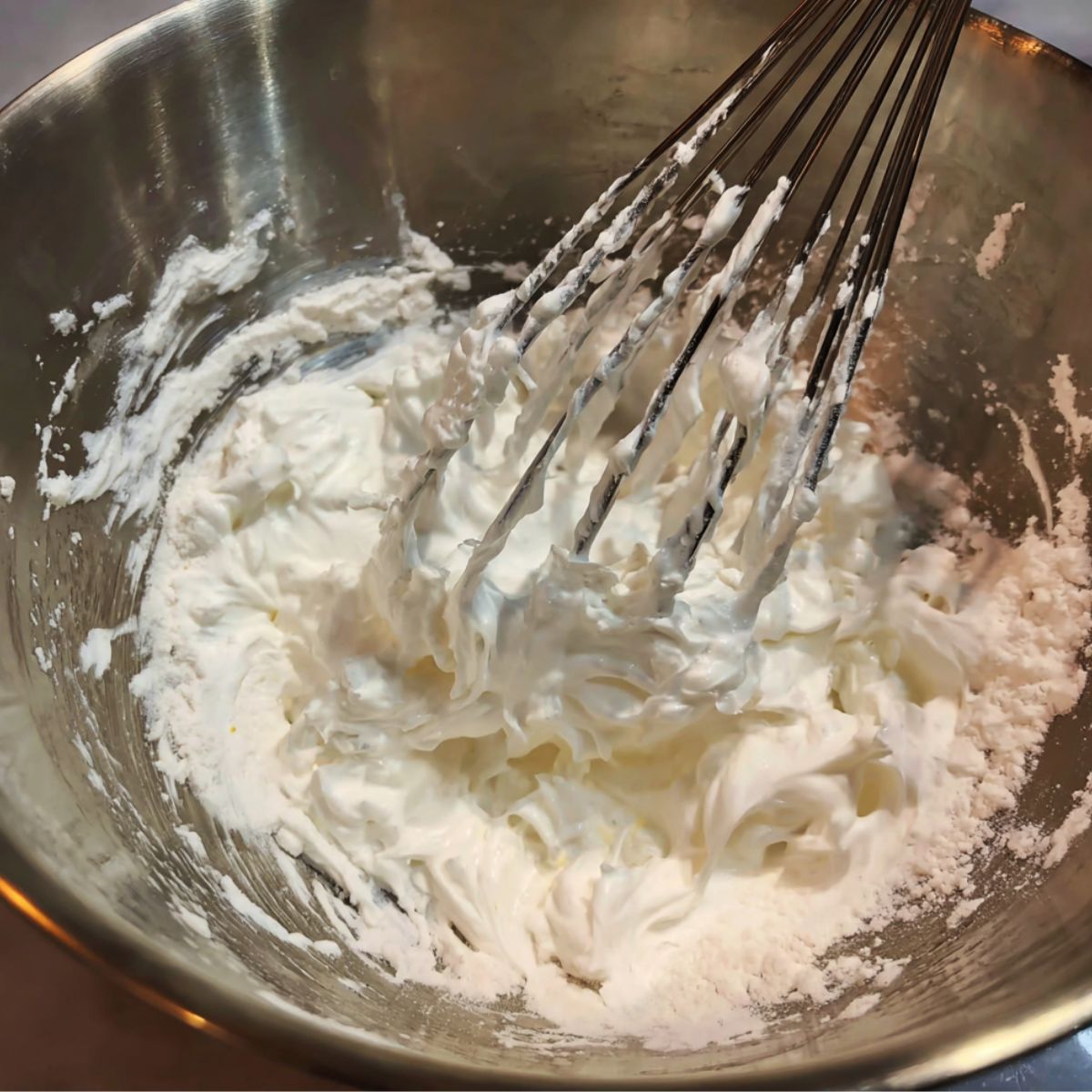 Flour being gently folded into the egg mixture