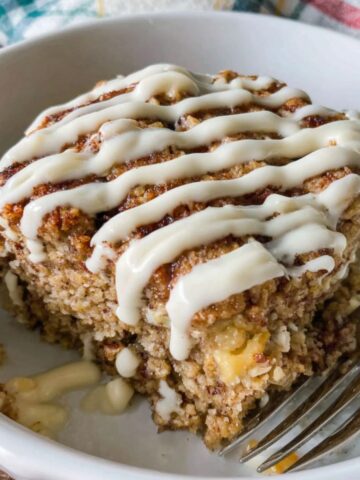Homemade cinnamon roll baked oatmeal in a dish with cinnamon swirls