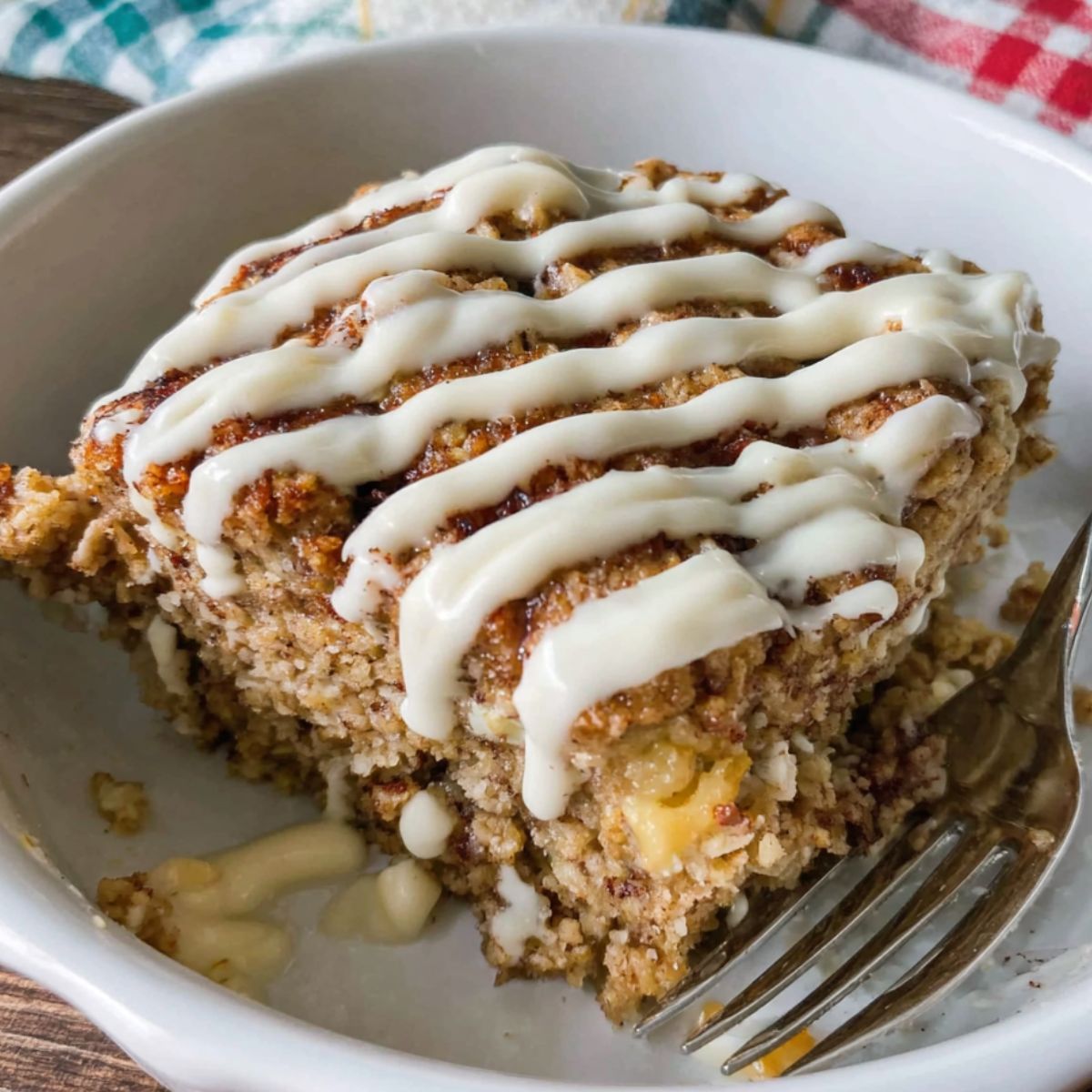 Homemade cinnamon roll baked oatmeal in a dish with cinnamon swirls