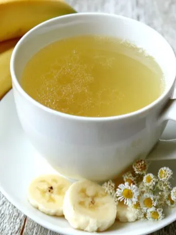 Homemade banana chamomile tea served in a mug on a kitchen counter,