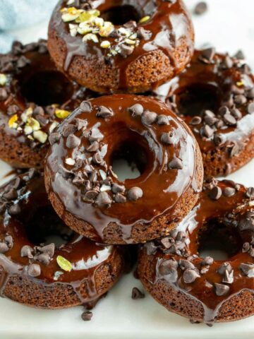Homemade chocolate protein donuts on a white counter.