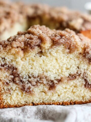 Homemade gluten free coffee cake with streusel topping on a white kitchen counter