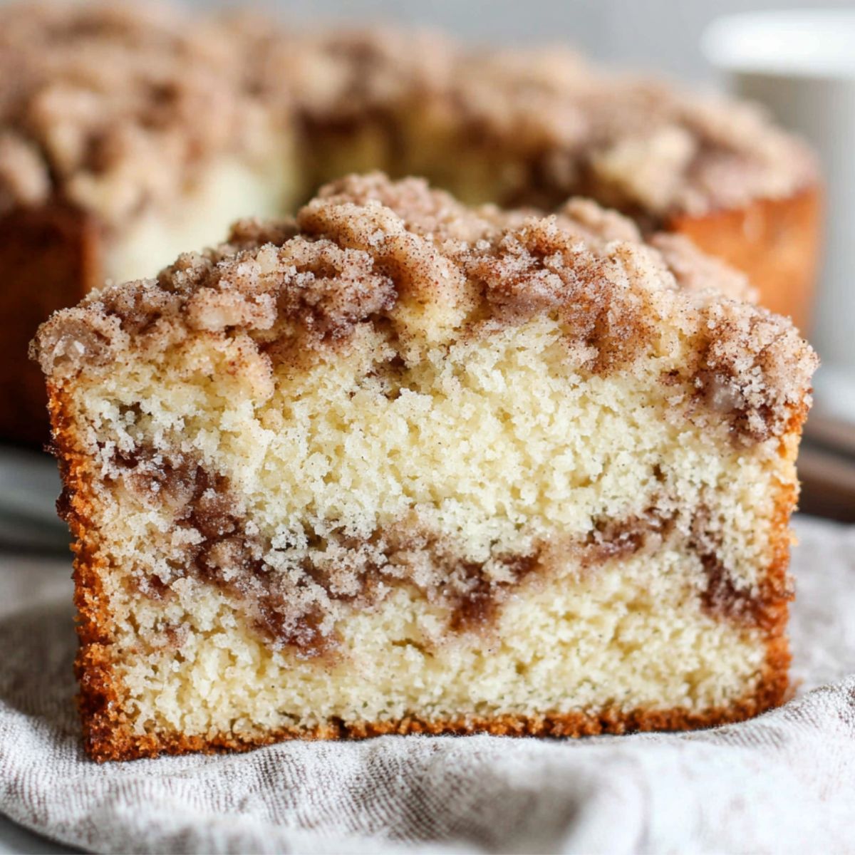 Homemade gluten free coffee cake with streusel topping on a white kitchen counter