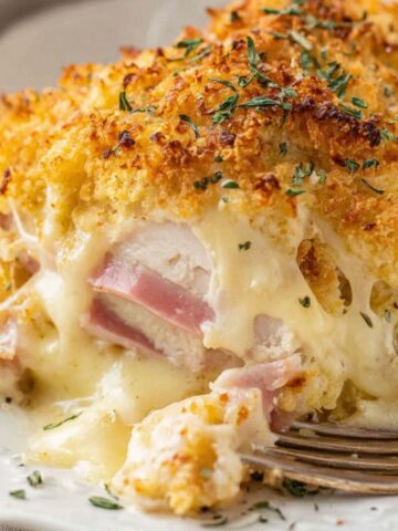 Homemade chicken cordon bleu casserole recipe with golden breadcrumb topping in a white plate.