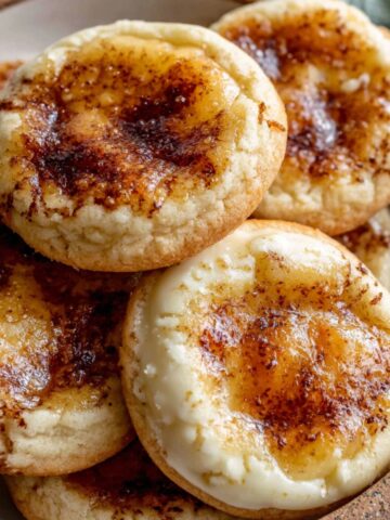 Homemade crème brûlée cookies with caramelized sugar topping on a white kitchen counter,