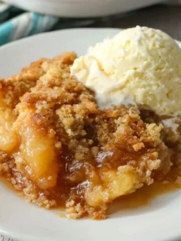 Homemade gluten free apple cobbler with golden crumble topping on a kitchen counter