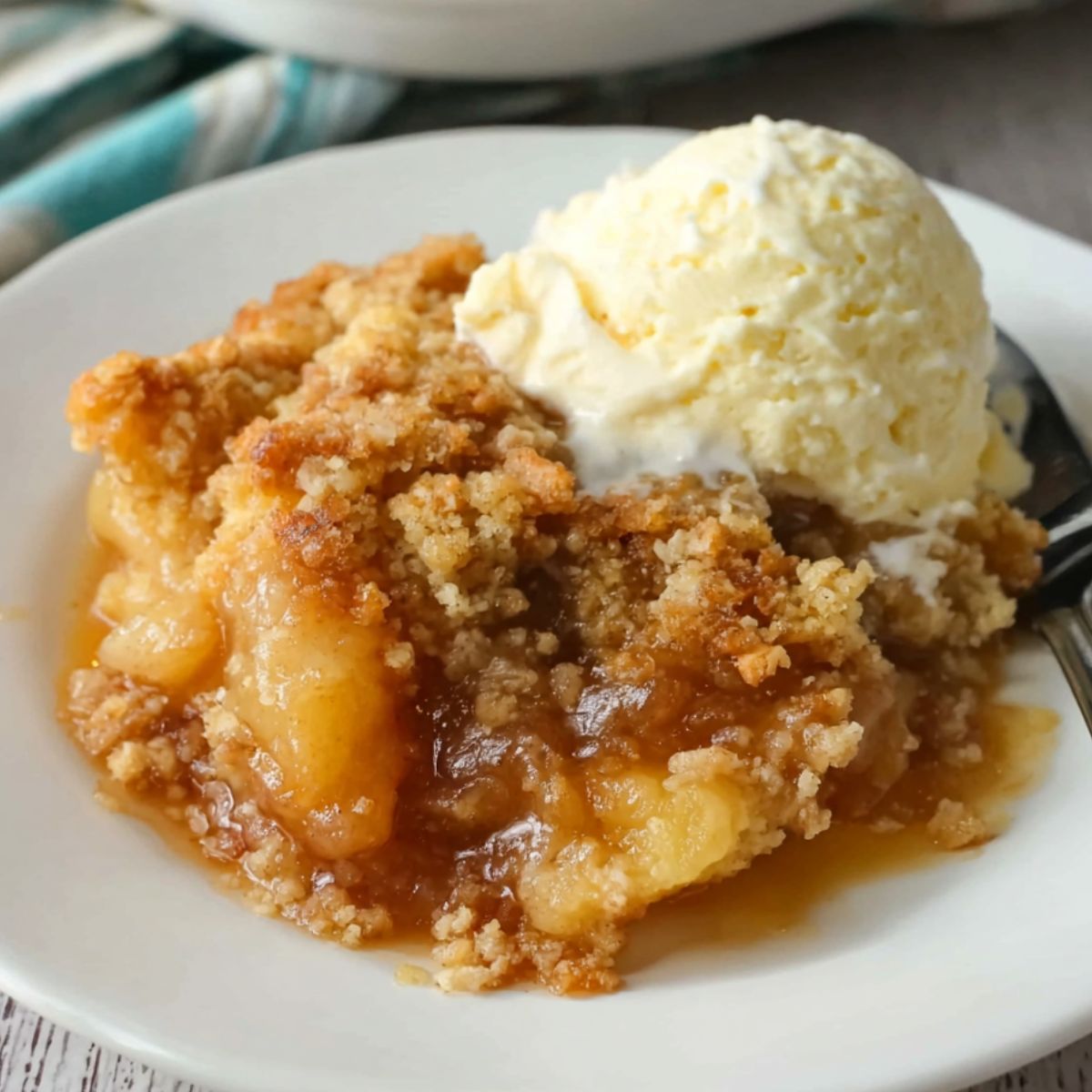 Homemade gluten free apple cobbler with golden crumble topping on a kitchen counter
