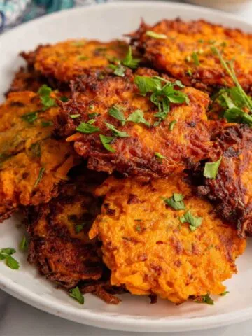 Crispy sweet potato hash browns served on a plate.
