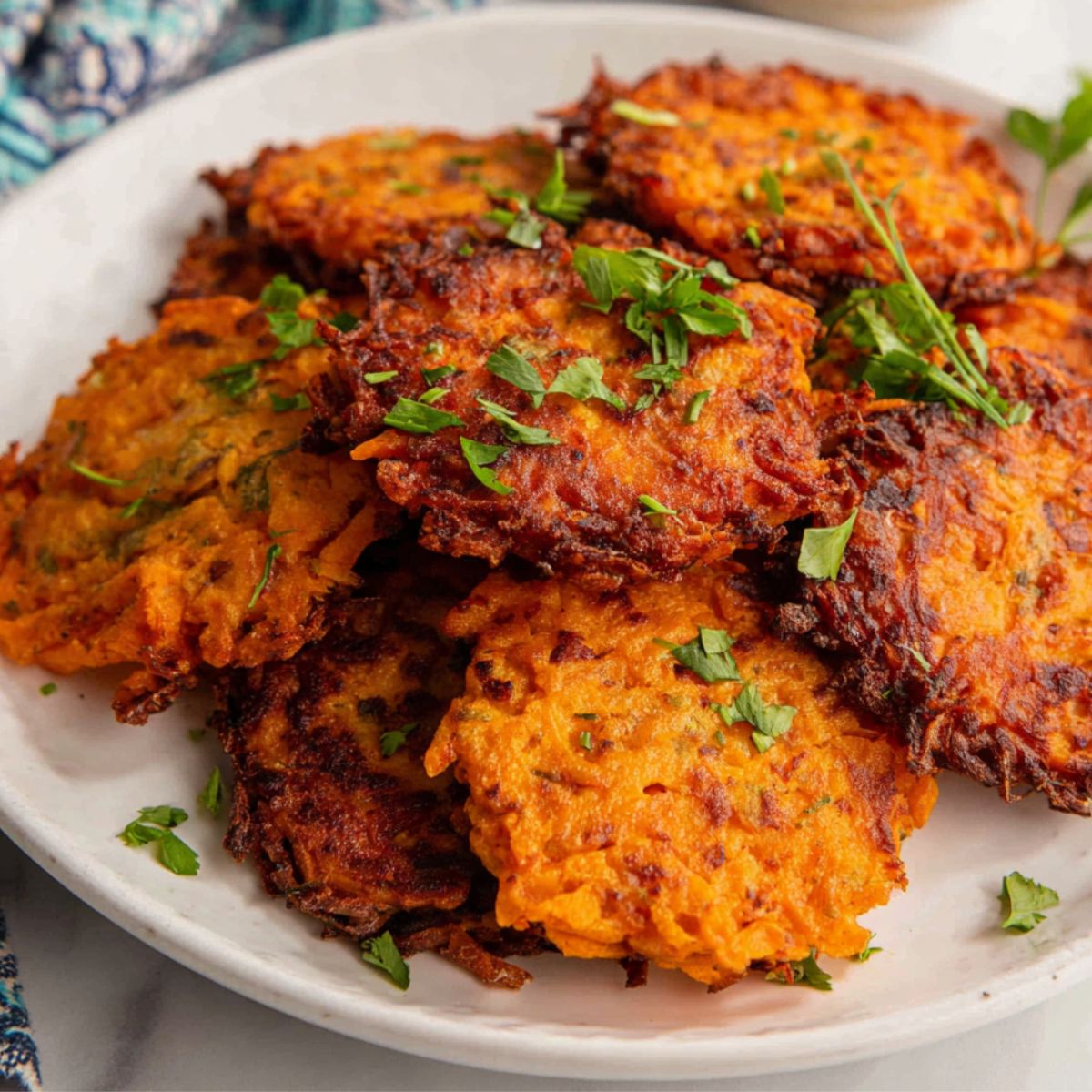 Crispy sweet potato hash browns served on a plate.