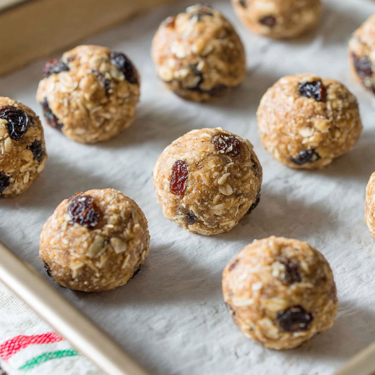 Cookie dough balls on a baking tray before baking