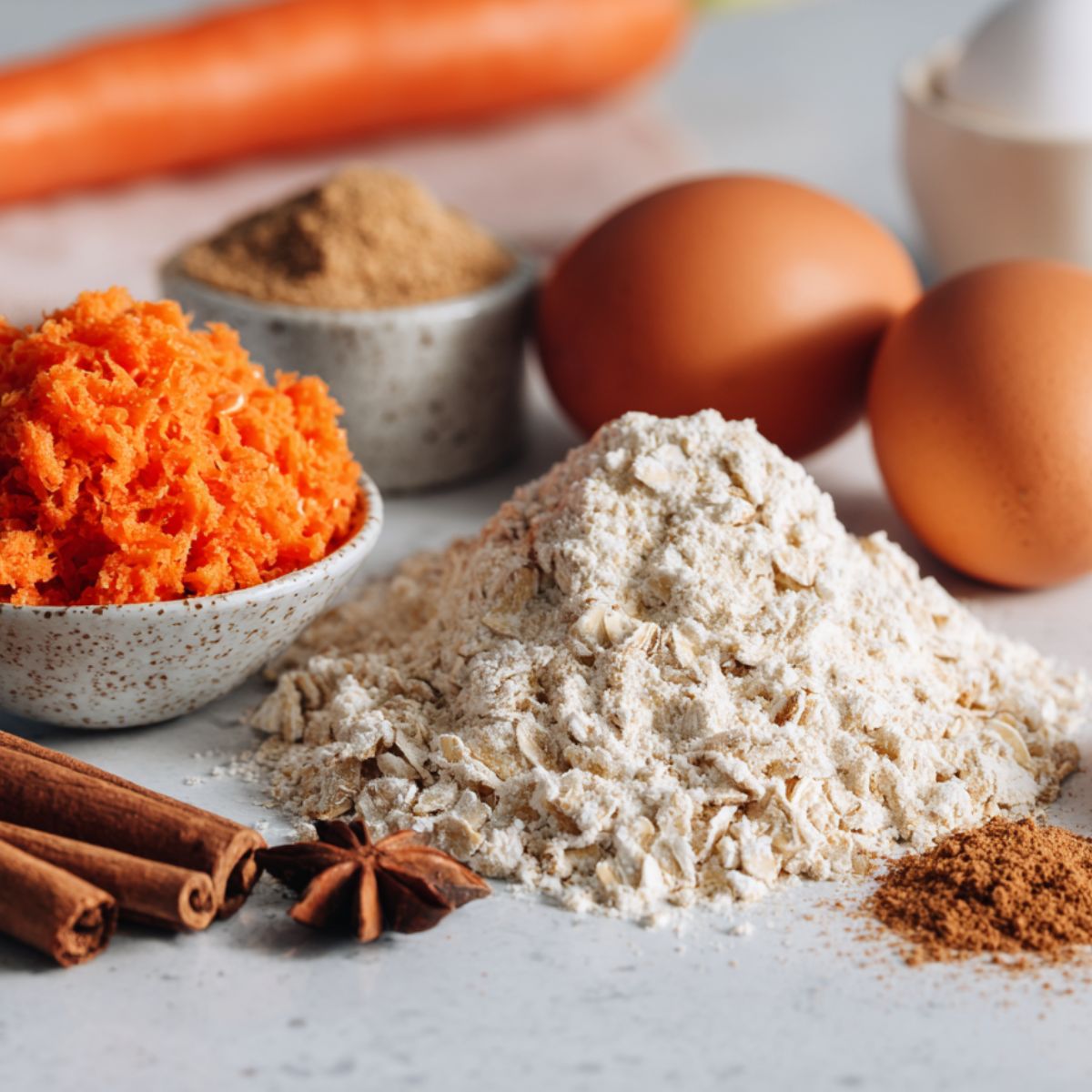 Carrot oatmeal cookie ingredients laid out on a white countertop