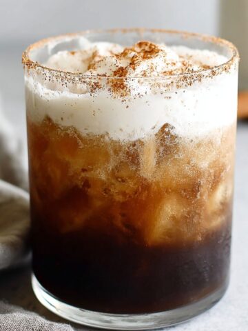 Homemade Mexican iced coffee served in a glass on a kitchen counter.