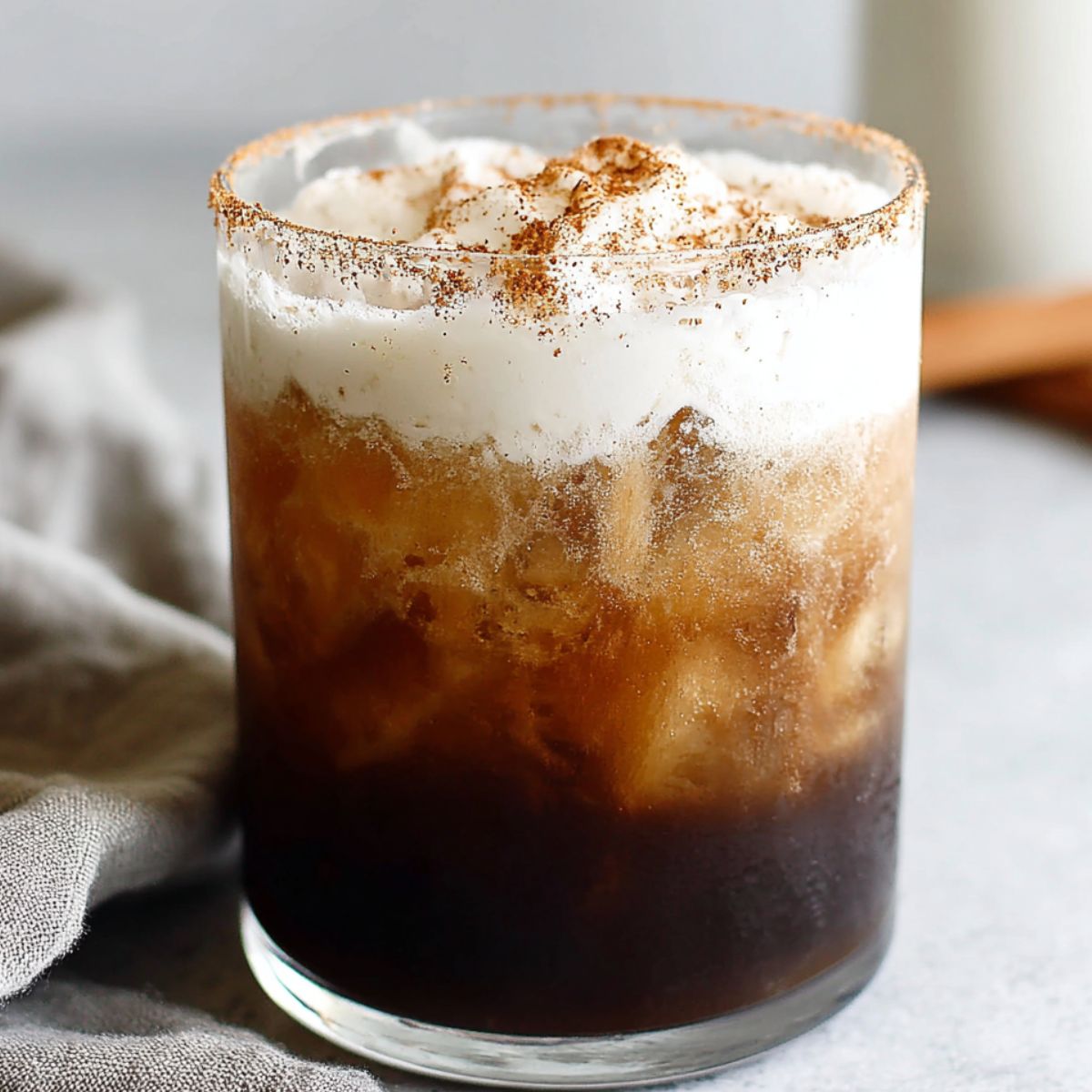 Homemade Mexican iced coffee served in a glass on a kitchen counter.