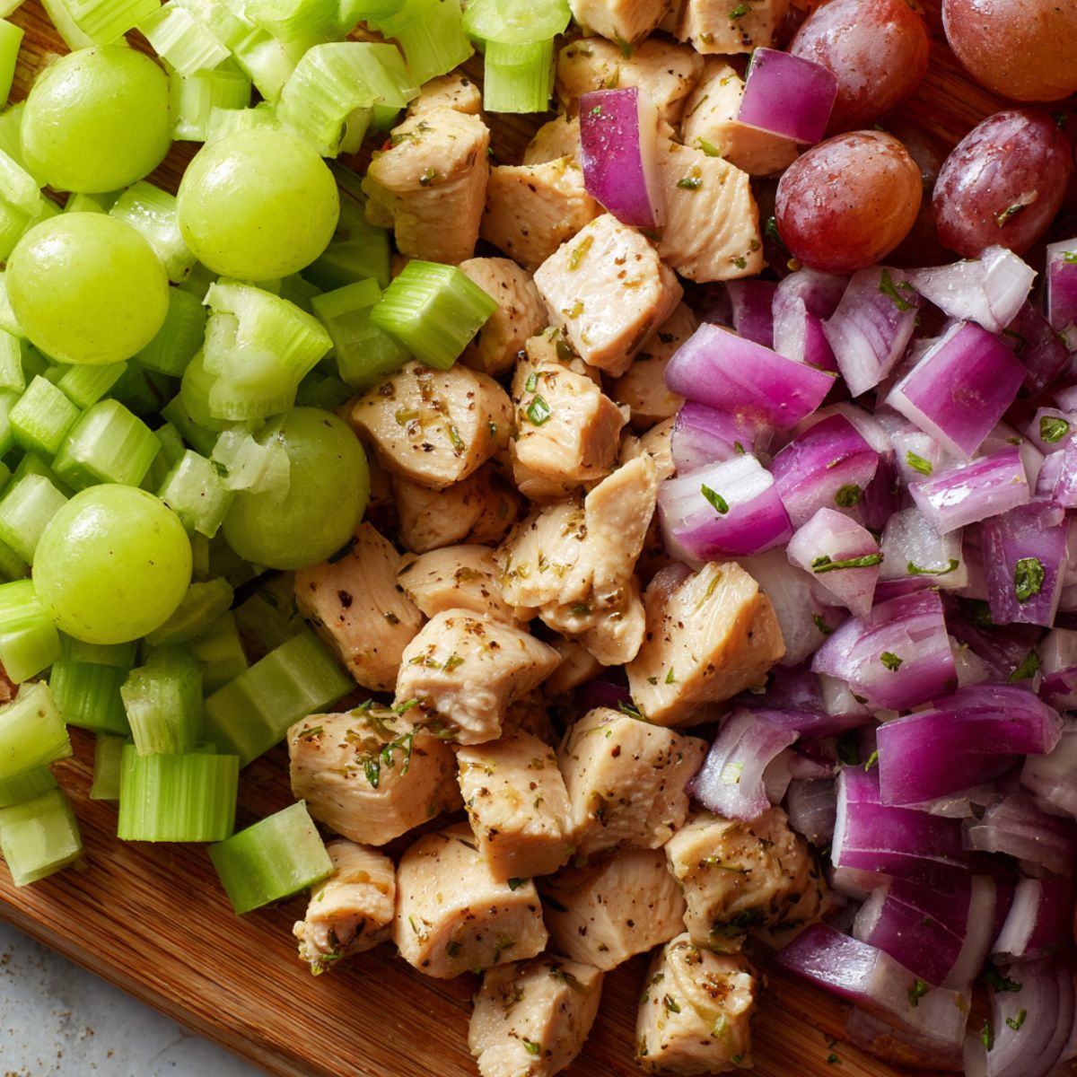 Diced chicken and chopped vegetables laid out on a counter