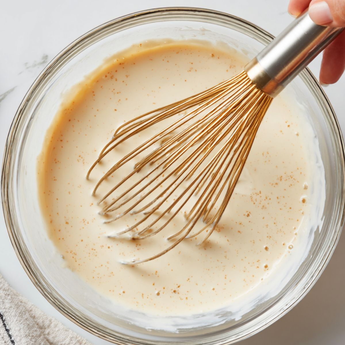 Mixing instant pudding with milk in a bowl