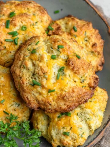 A stack of homemade protein breakfast biscuits on a kitchen counter