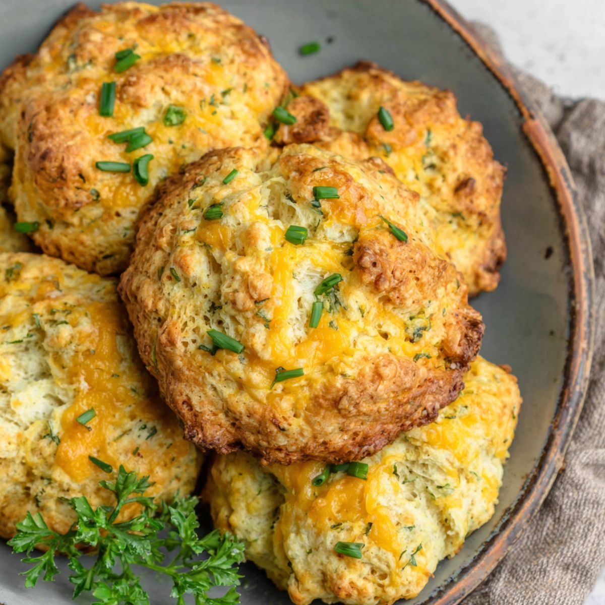 A stack of homemade protein breakfast biscuits on a kitchen counter