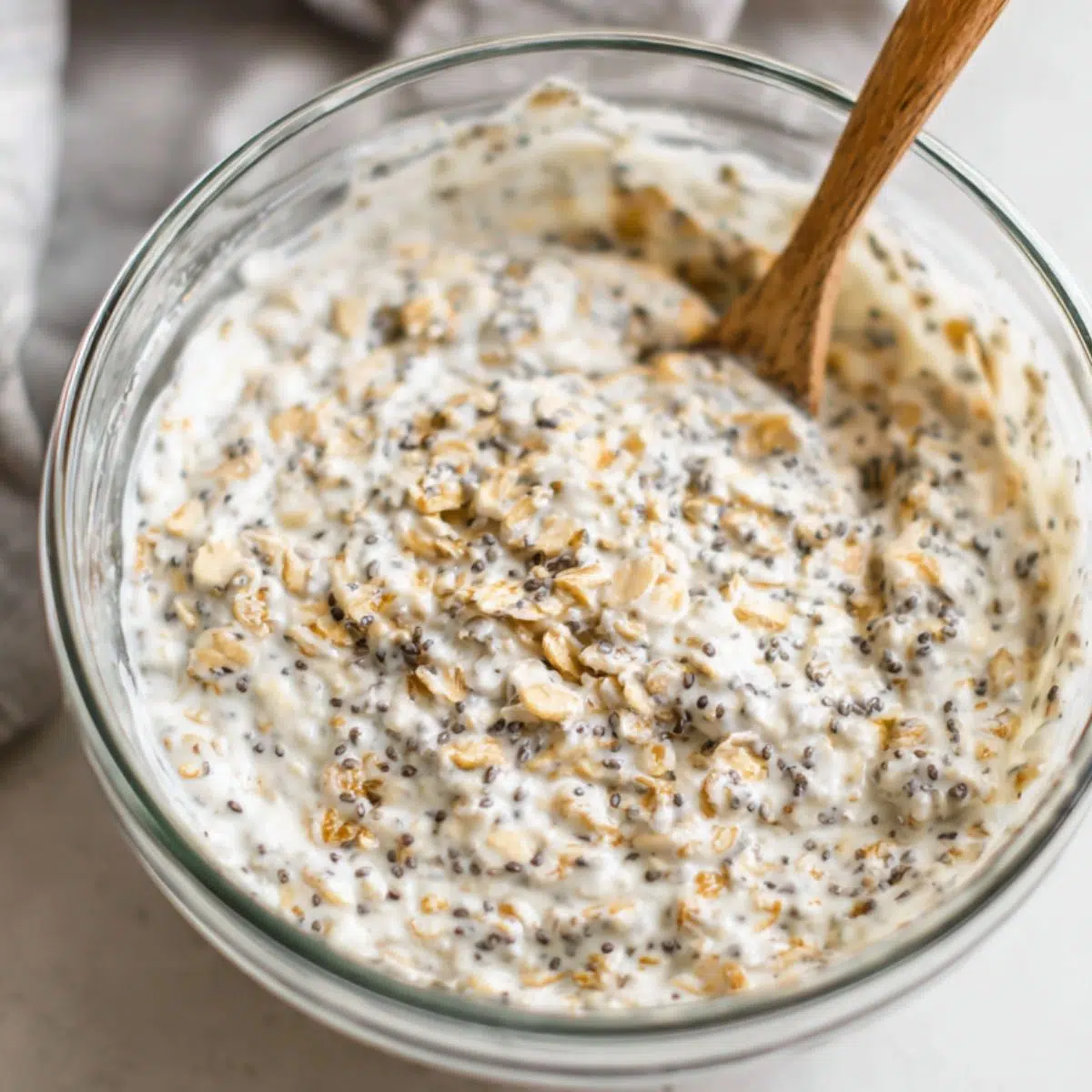 Mixing cream cheese, yogurt, and oats in a bowl for overnight oats