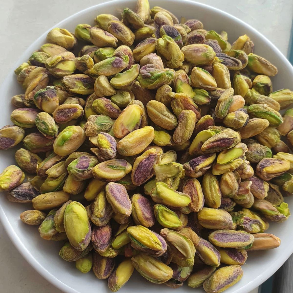 Toasted pistachios cooling on a plate