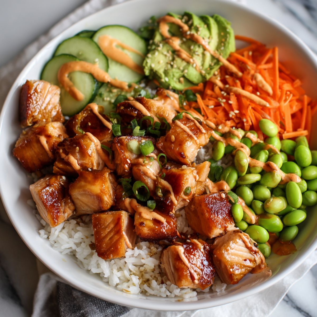 Assembling a salmon bowl with salmon, rice, and vegetables