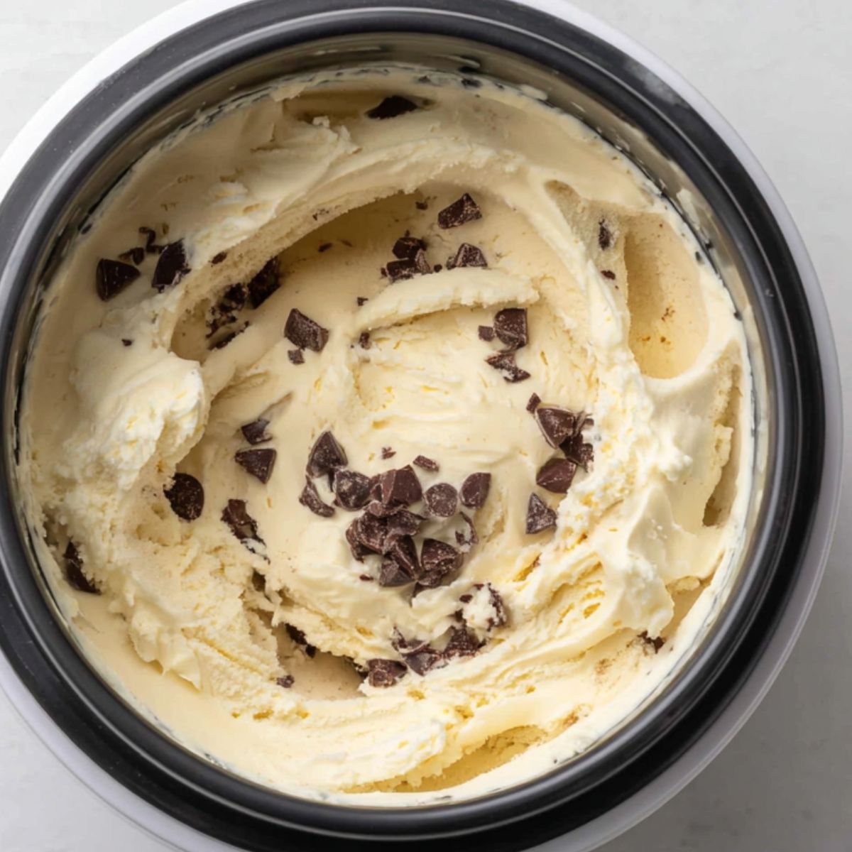 Adding chocolate chips to ice cream in the final minutes of churning.