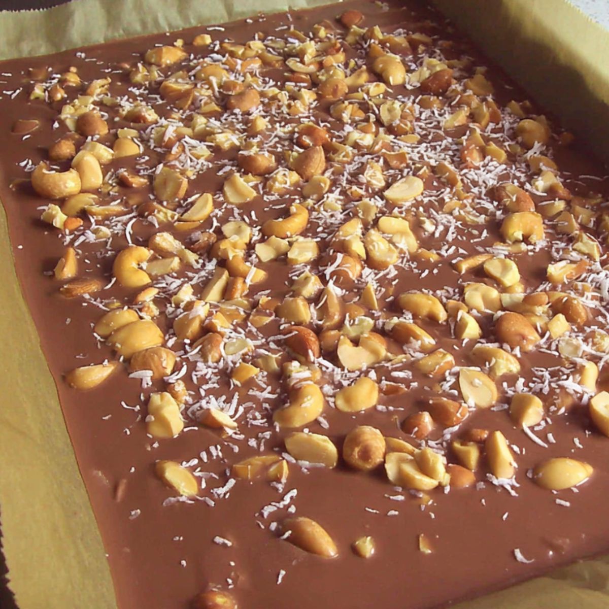 Chocolate bark topped with nuts before setting