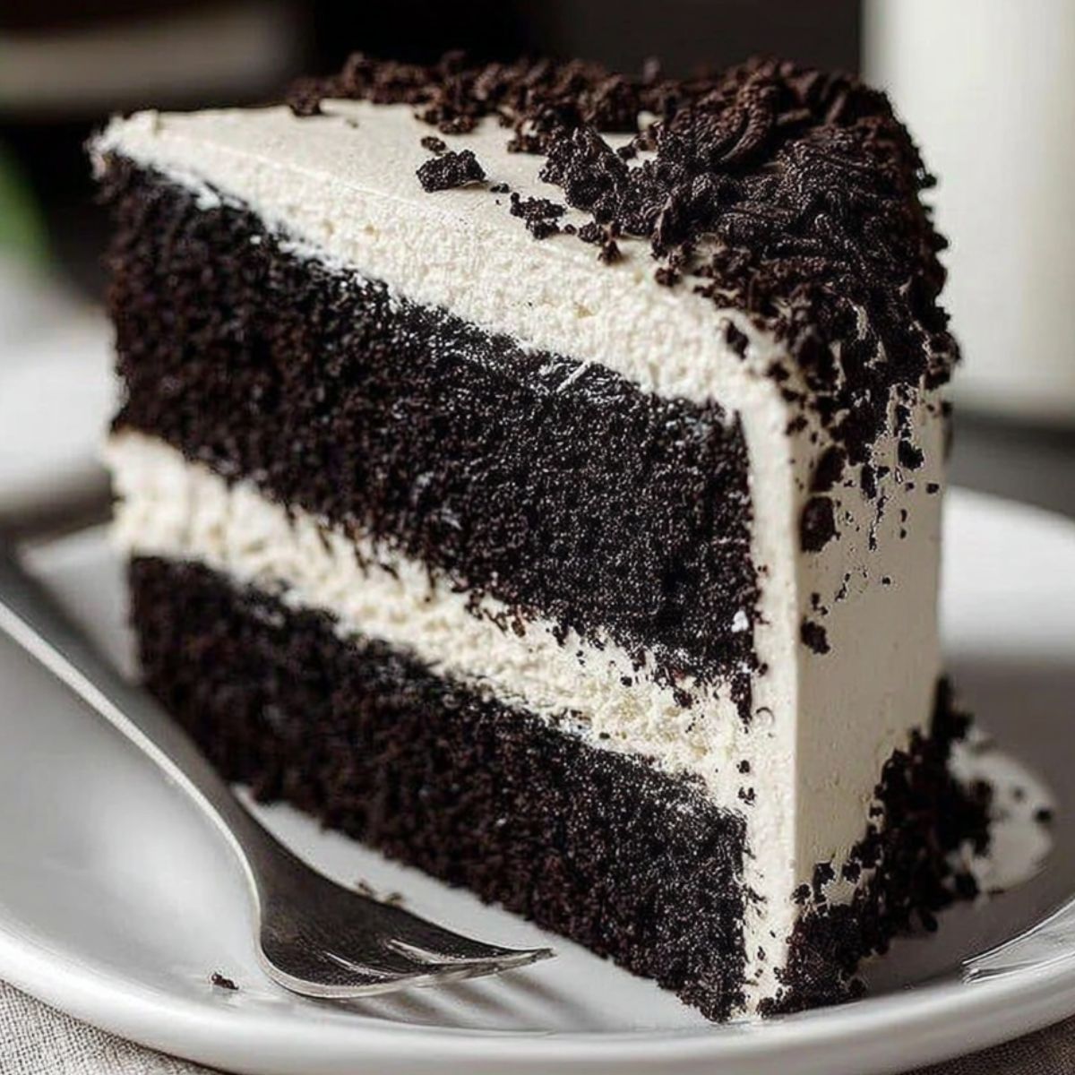 Homemade black velvet cake with cream cheese frosting on a white kitchen counter shot from above