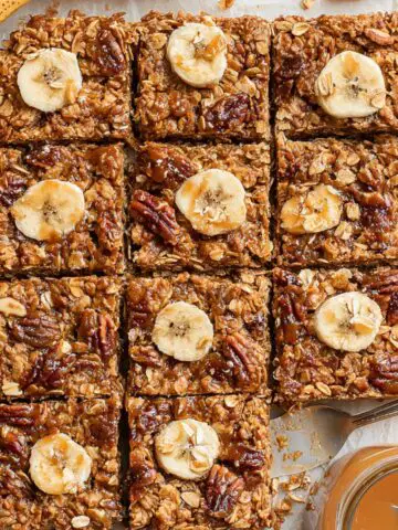Homemade oatmeal banana bars cut into squares on parchment paper