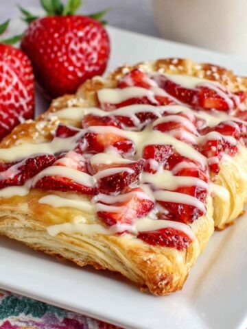 Homemade strawberry Danish pastries on a white kitchen counter photographed from above with a casual breakfast vibe