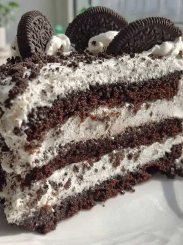 Homemade cookies and cream filling cake on a white kitchen counter