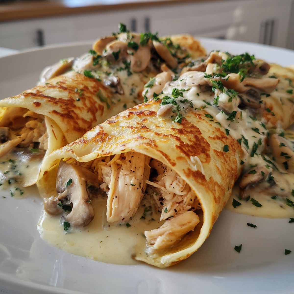 Homemade crepes de pollo rolled with chicken and cheese on a white kitchen countertop