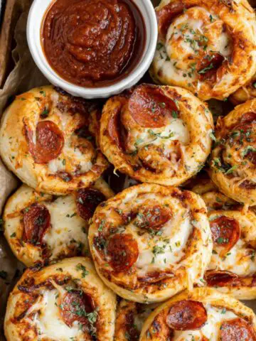 Freshly baked homemade spicy pepperoni pizza rolls on a white kitchen counter shot from above.