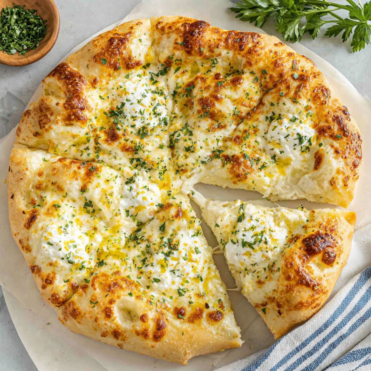 Homemade white sauce pizza recipe fresh out of the oven on a rustic white kitchen counter