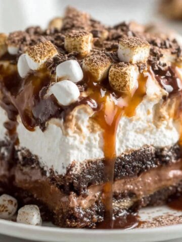 Homemade hot chocolate lasagna with rich layers of pudding, whipped topping, and Oreo crust