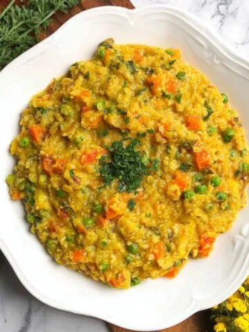 Homemade masala oats recipe indian served on a white kitchen counter