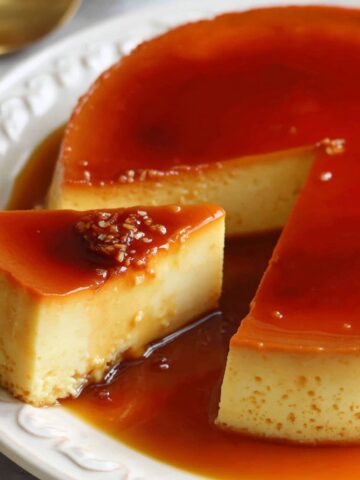 Homemade coconut flan with caramel topping on a white kitchen counter