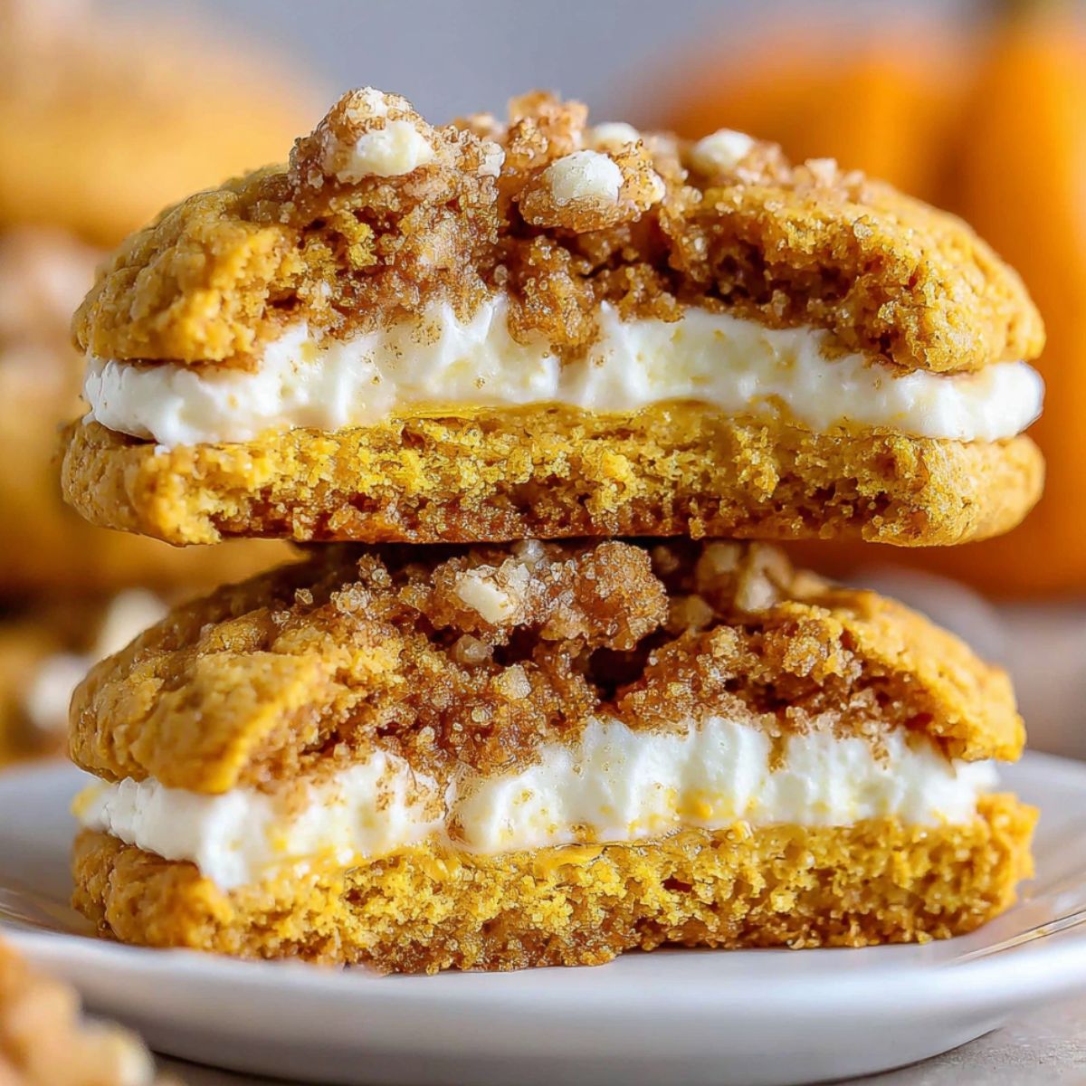 Overhead shot of homemade pumpkin cheesecake cookies on a white kitchen counter with a cozy fall vibe.