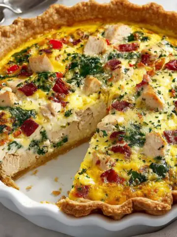 Homemade chicken quiche on a white kitchen counter