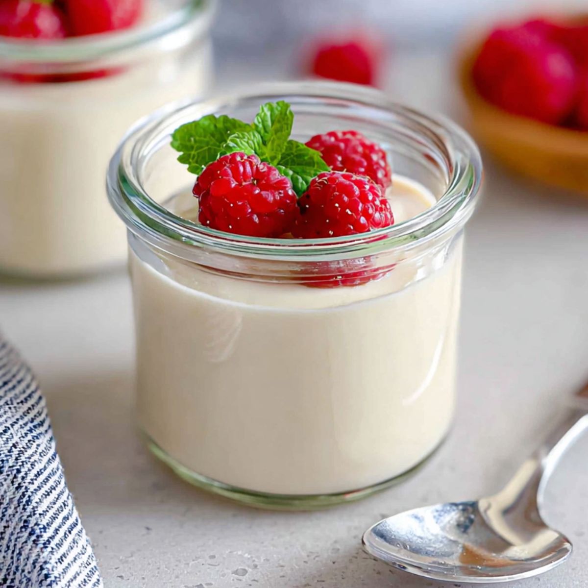 Homemade coconut panna cotta with mango and passion fruit topping on a white kitchen counter,
