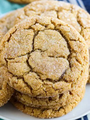 A batch of 3 ingredient brown sugar cookies on a white kitchen counter with crumbs and warm natural light.
