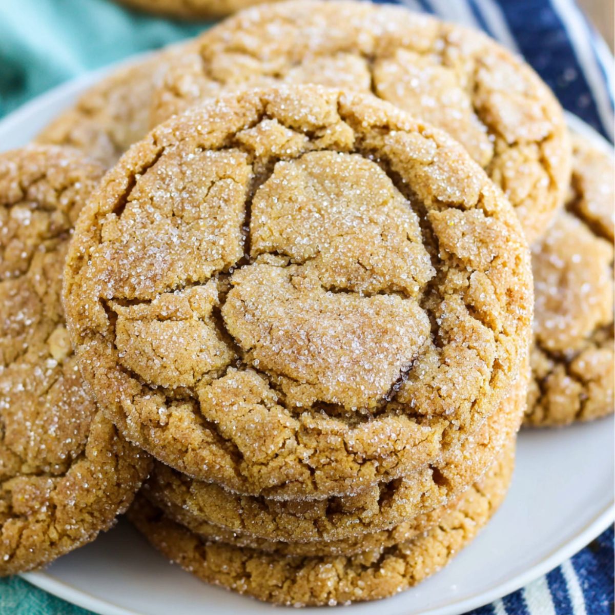 A batch of 3 ingredient brown sugar cookies on a white kitchen counter with crumbs and warm natural light.