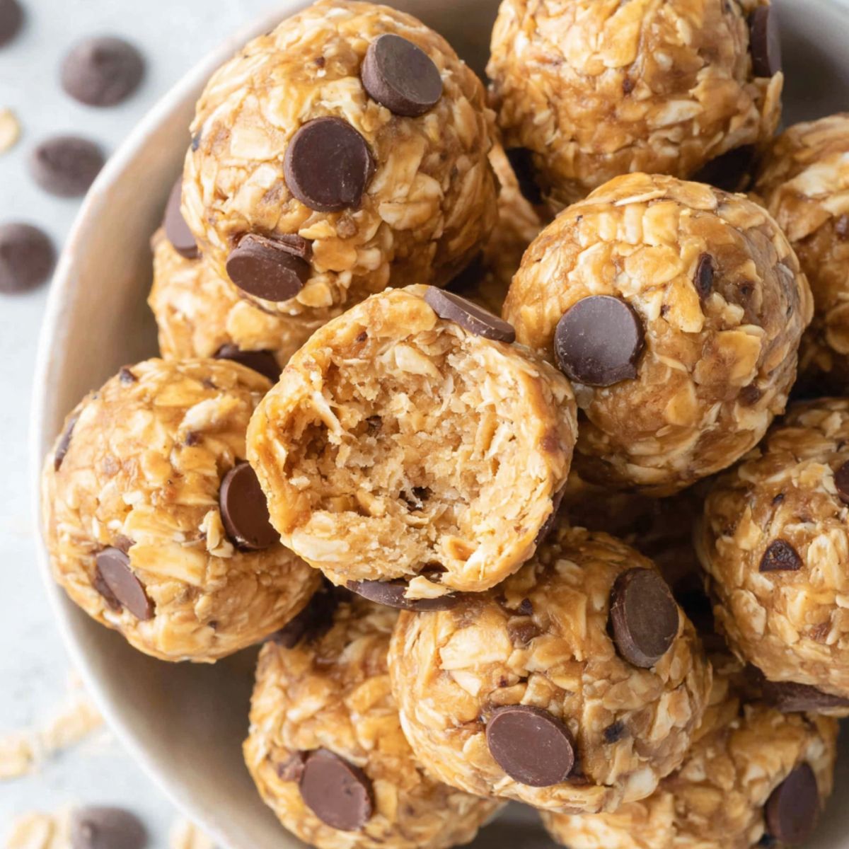 A small batch of homemade cottage cheese protein balls on a white kitchen counter, top-down view