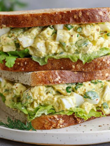 Homemade deviled egg salad sandwich on a white counter