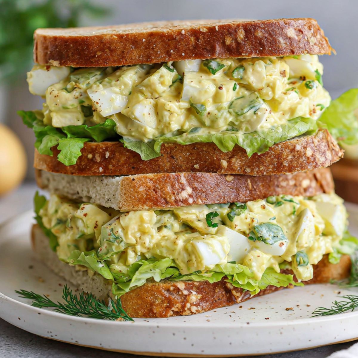 Homemade deviled egg salad sandwich on a white counter